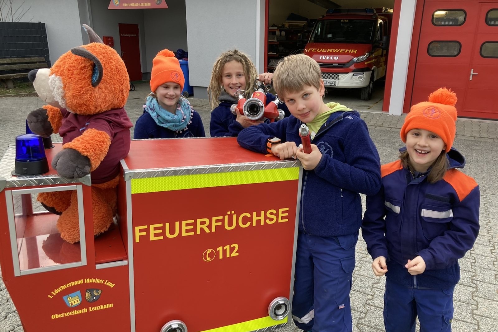 Mehrere Kinder in Feuerwehranzügen
